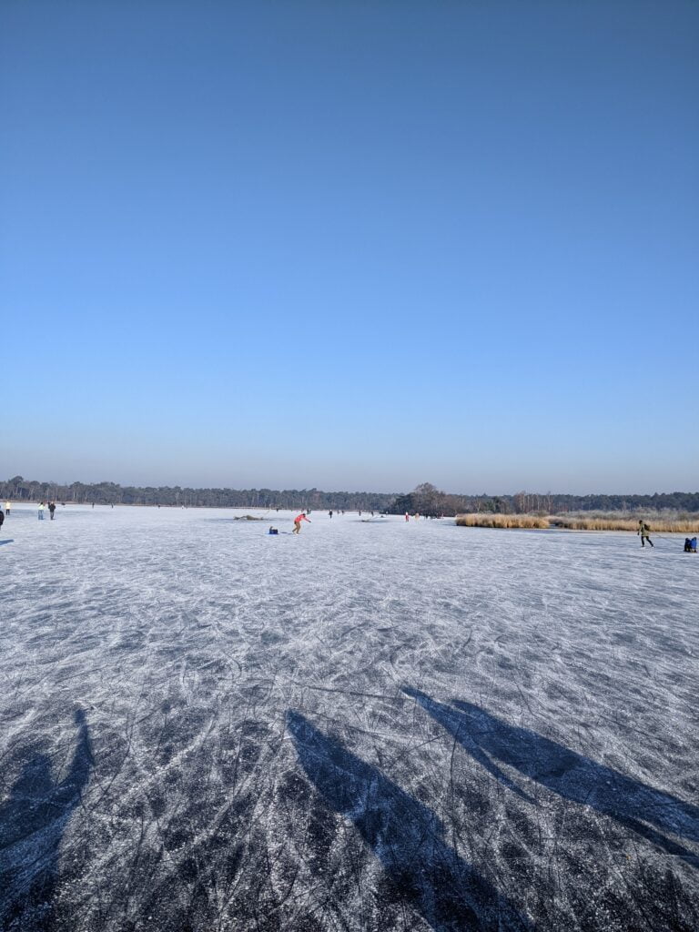 bevroren ven met schaatser op de Kalmthoutse Heide